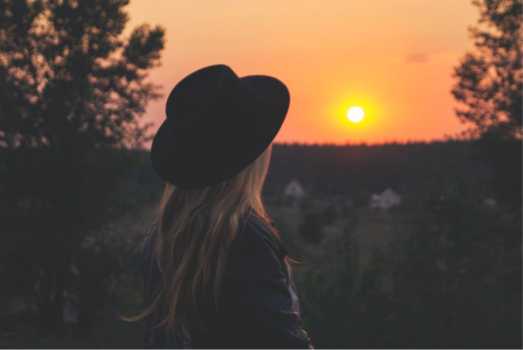 woman looking at sunset